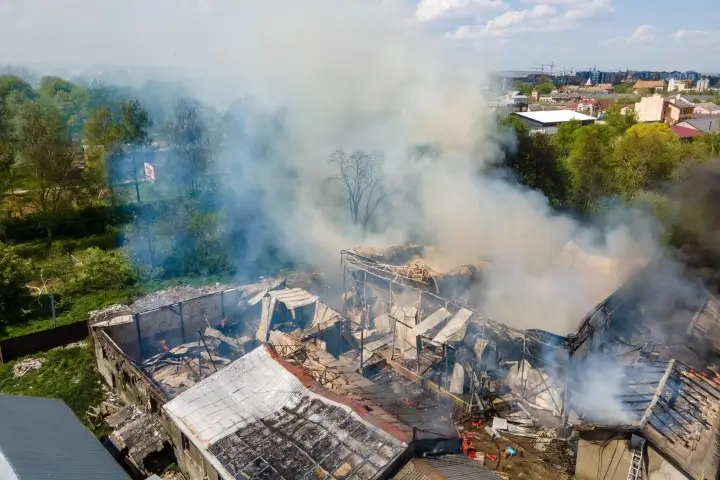 Aerial view of a building ruined by fire and smoke.