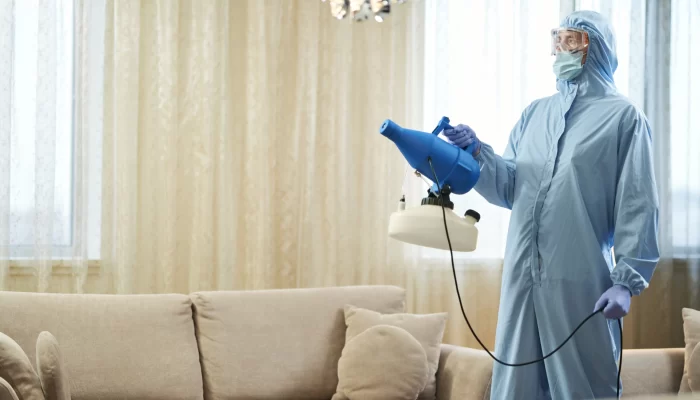 Worker removing odor from a living room